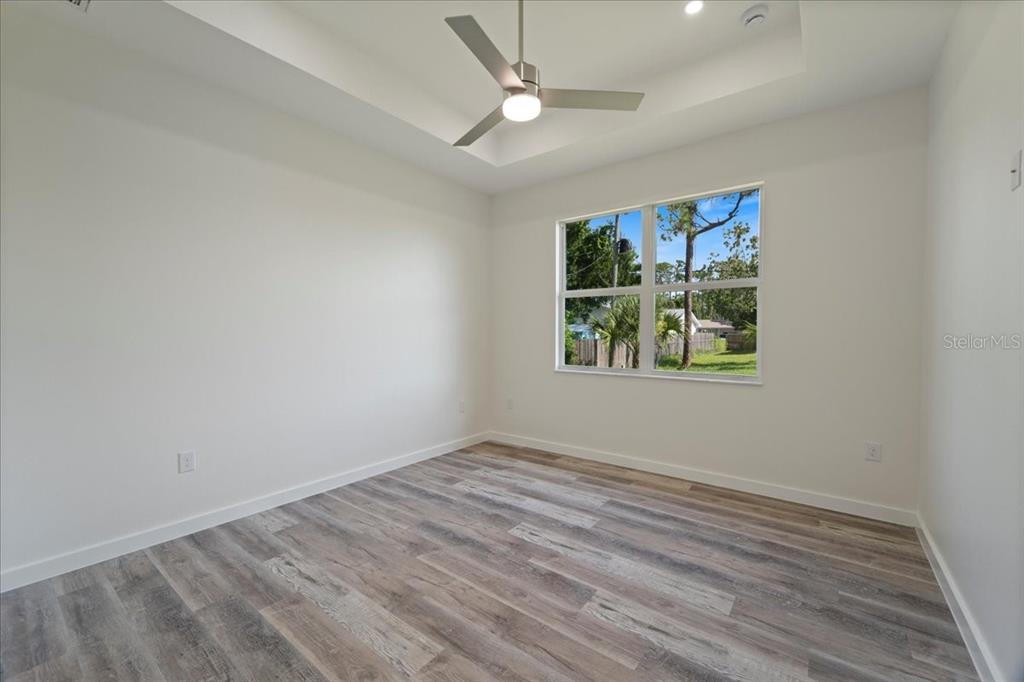 3299 Pinetree Street Port Charlotte, FL 33952 - Photo 5 of 6 wooden floor in an empty room with a window
