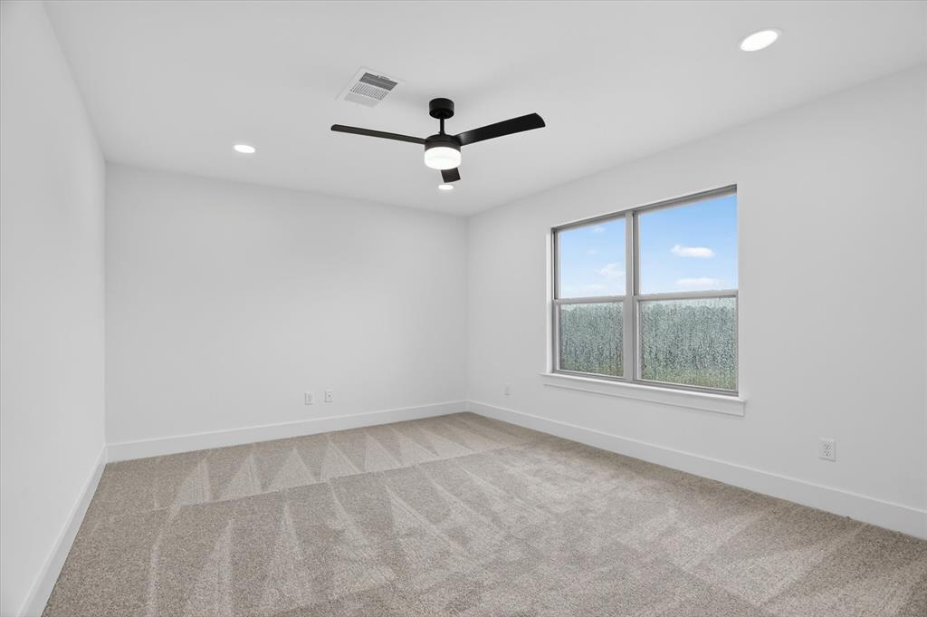 225 Kilkenny Road Poolville, TX 76487 - Photo 24 of 36 Spacious room featuring neutral carpeting, recessed lighting, and a modern ceiling fan with integrated lighting