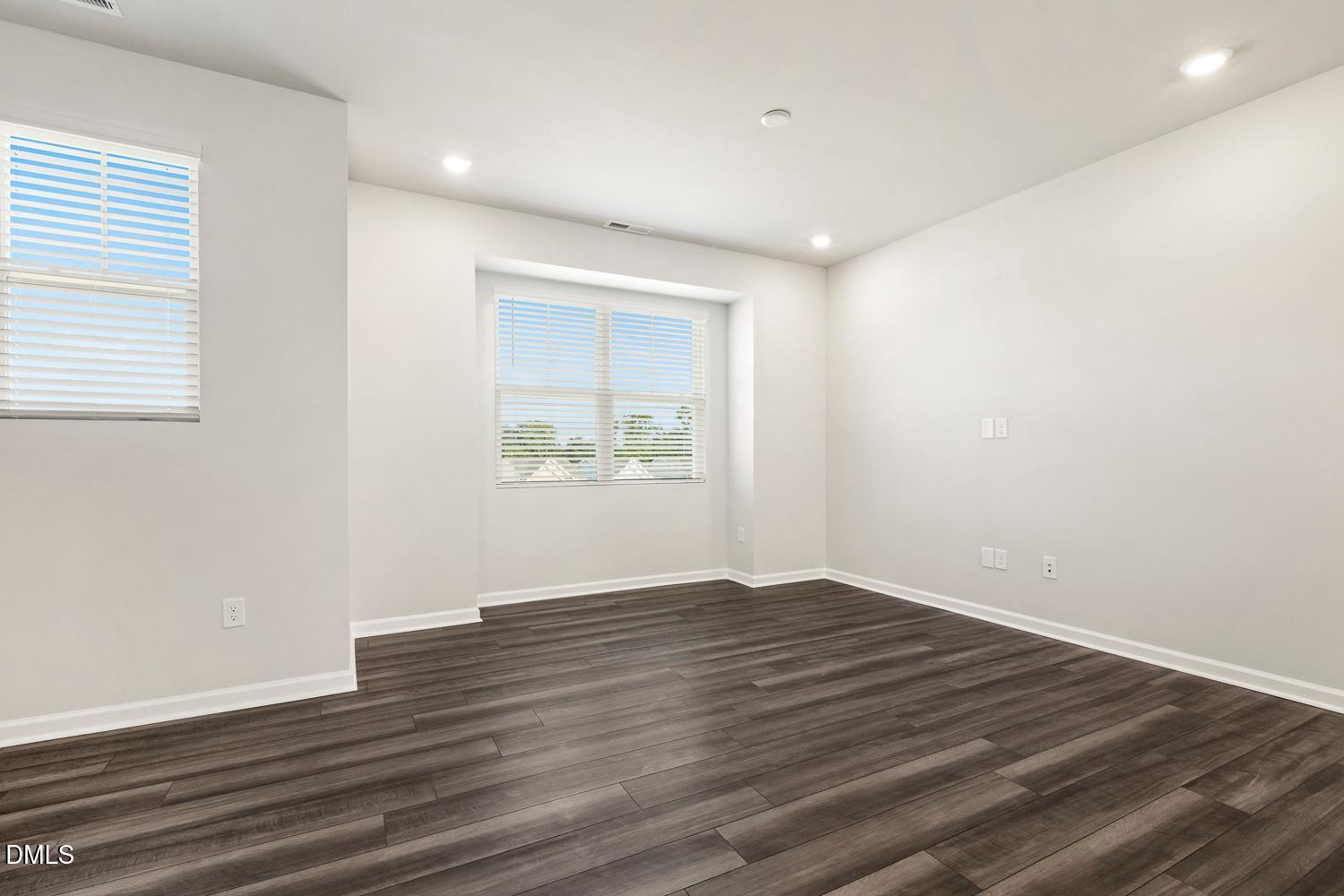 146 Zealand Court Raleigh, NC 27610 - Photo 20 of 45 an empty room with wooden floor and windows