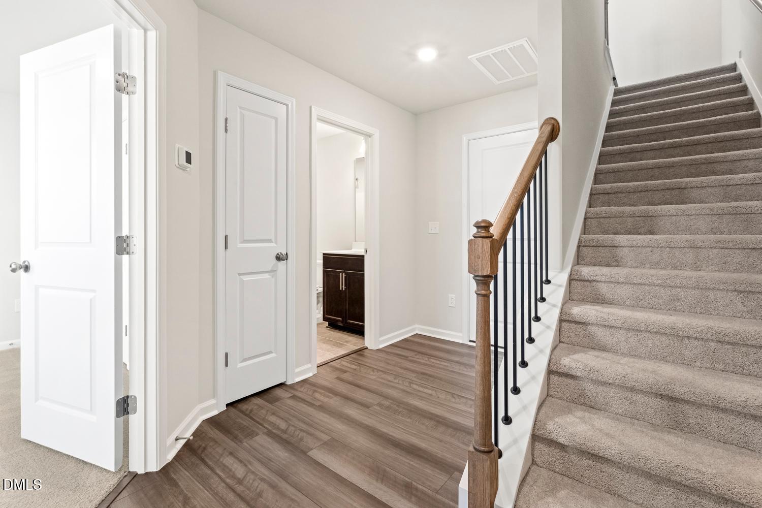 146 Zealand Court Raleigh, NC 27610 - Photo 3 of 45 a view of a hallway with wooden floor and entryway