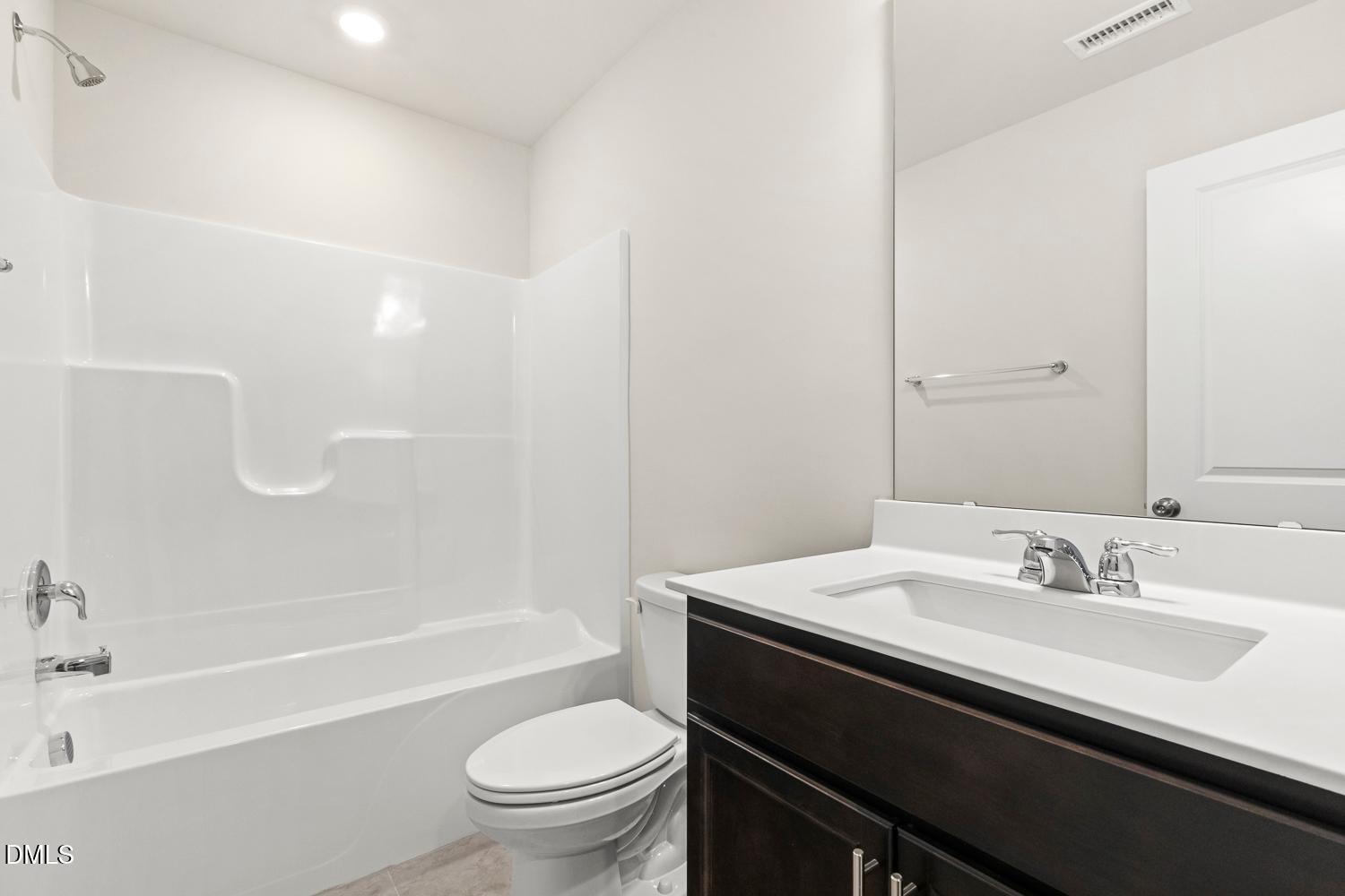 146 Zealand Court Raleigh, NC 27610 - Photo 6 of 45 a bathroom with a sink a toilet and a bathtub