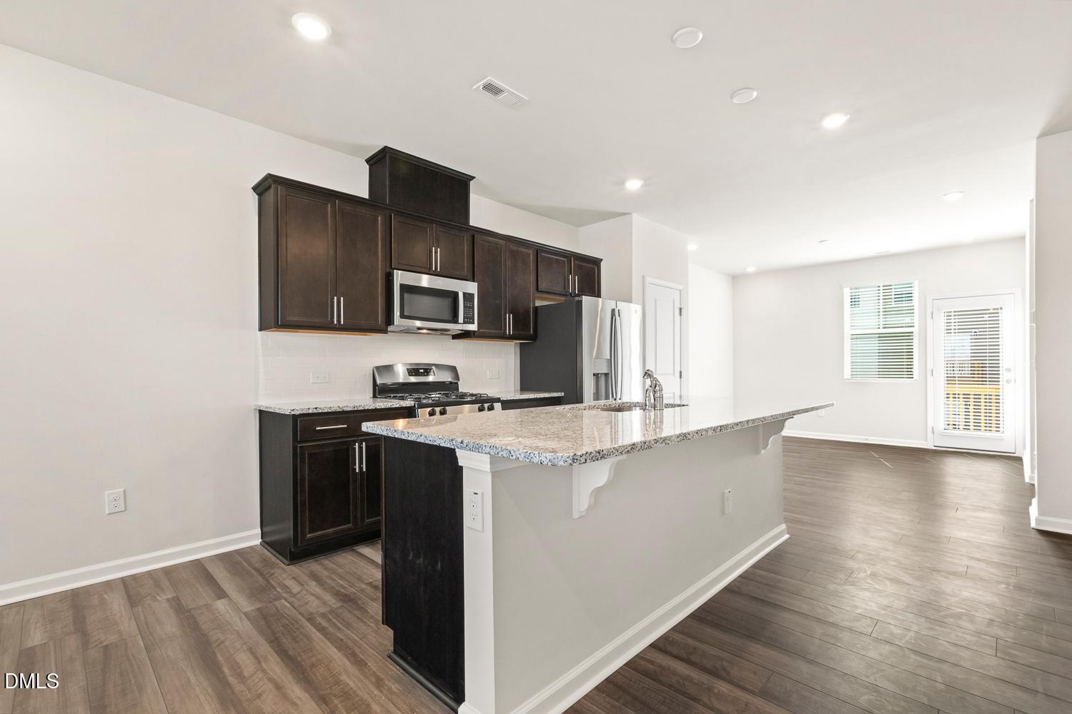 146 Zealand Court Raleigh, NC 27610 - Photo 10 of 45 a kitchen with stainless steel appliances a sink stove and refrigerator