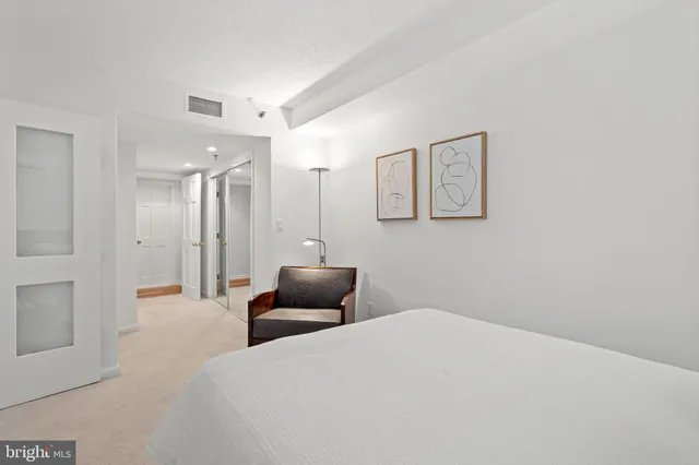 a bedroom with a bed and a couch