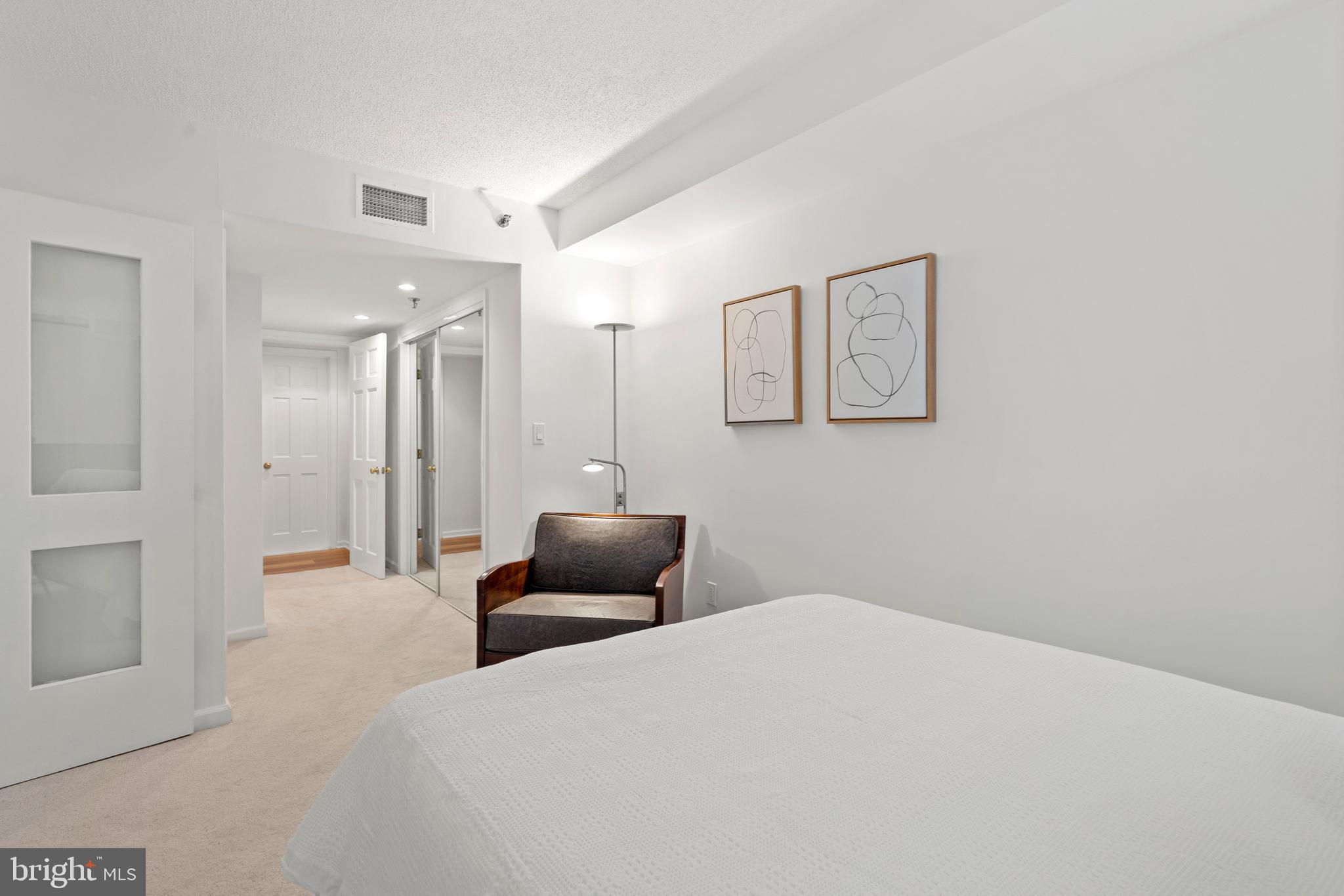 801 Pennsylvania Avenue Northwest, Unit 1125 Washington, DC 20004 - Photo 11 of 25 a bedroom with a bed and a couch