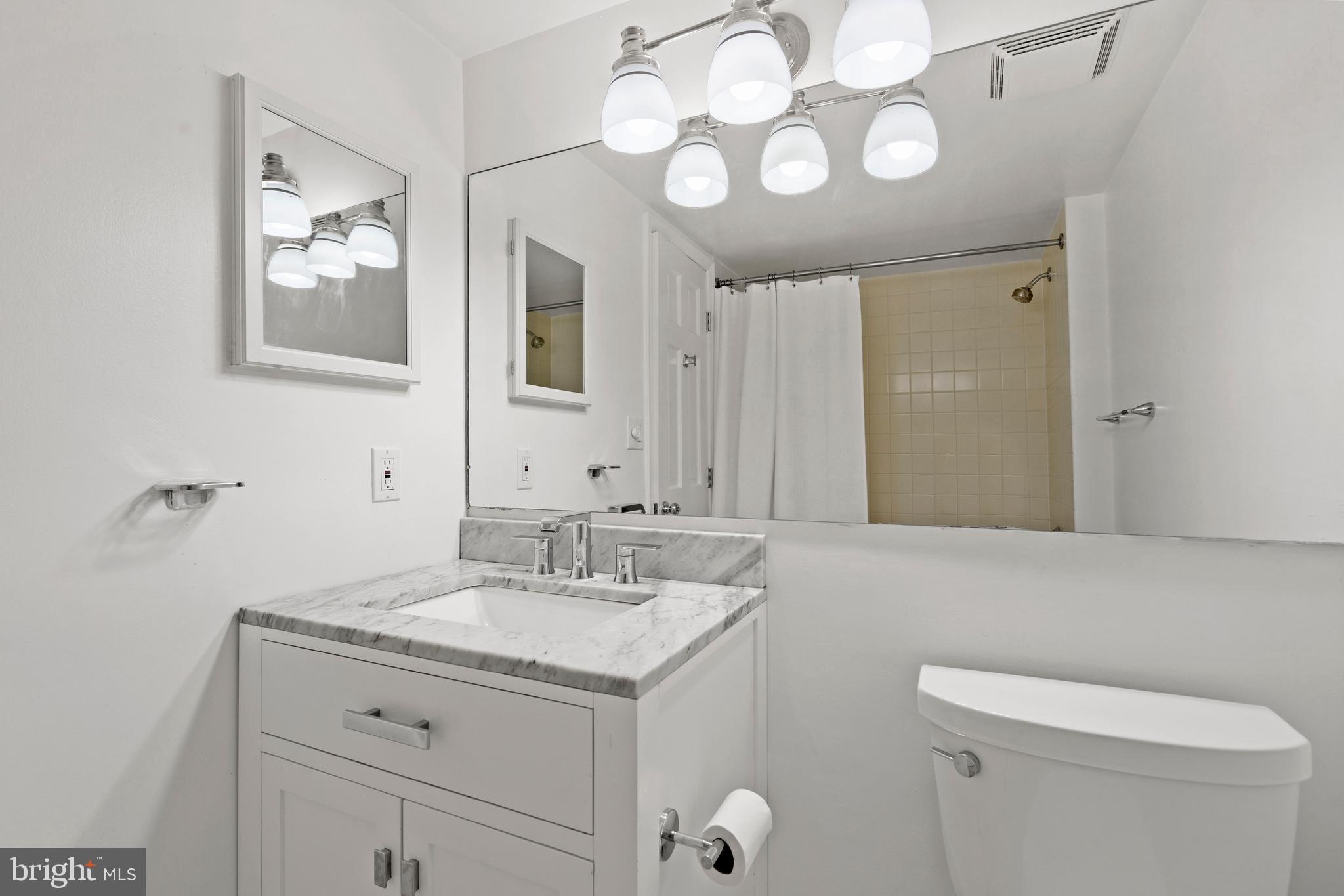 801 Pennsylvania Avenue Northwest, Unit 1125 Washington, DC 20004 - Photo 14 of 25 a bathroom with a toilet sink and mirror