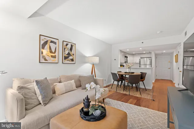 a living room with furniture and a dining table