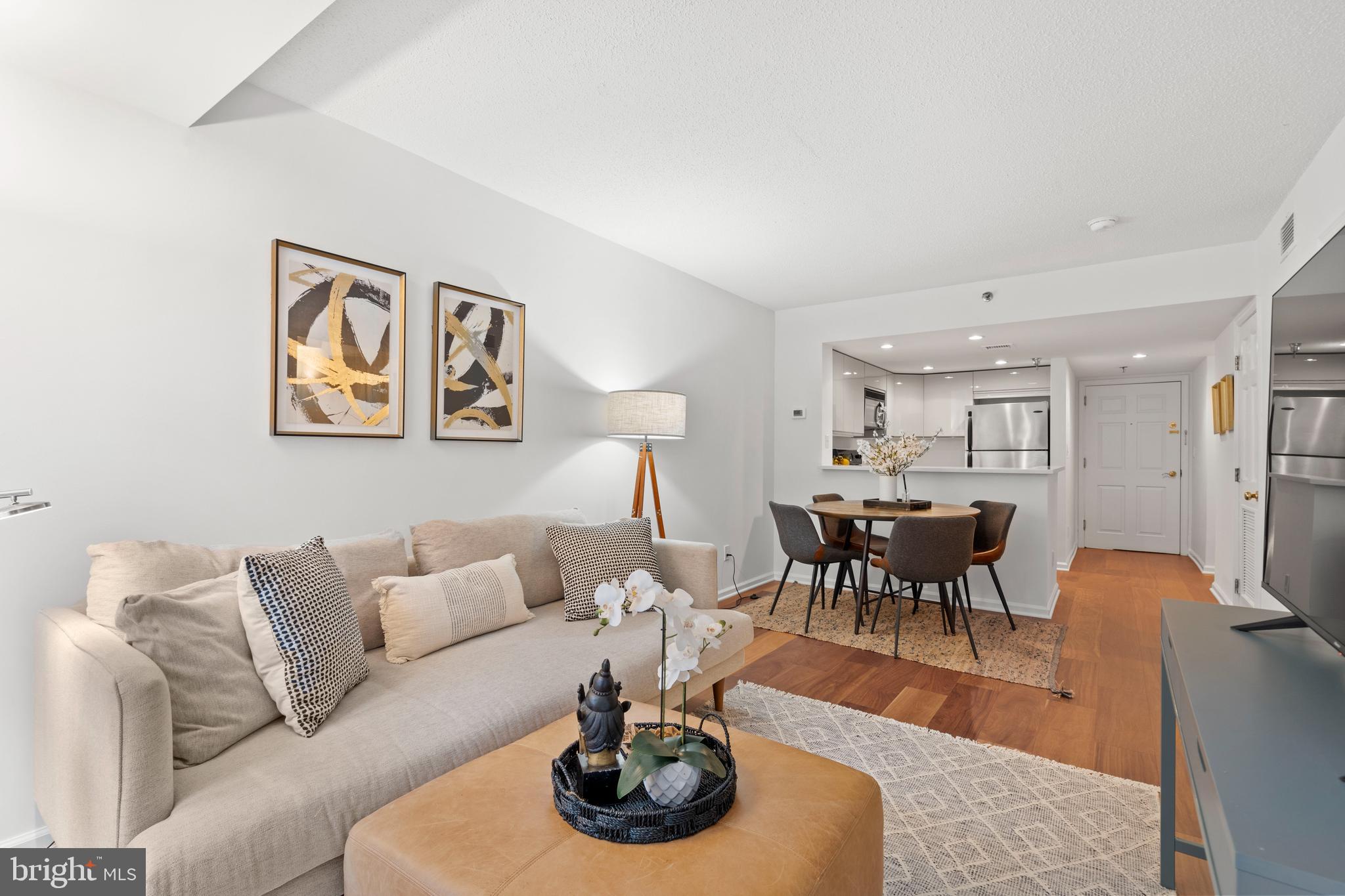 801 Pennsylvania Avenue Northwest, Unit 1125 Washington, DC 20004 - Photo 2 of 25 a living room with furniture and a dining table