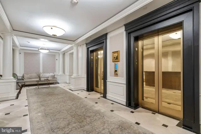 a view of a hallway with a large mirror and sink