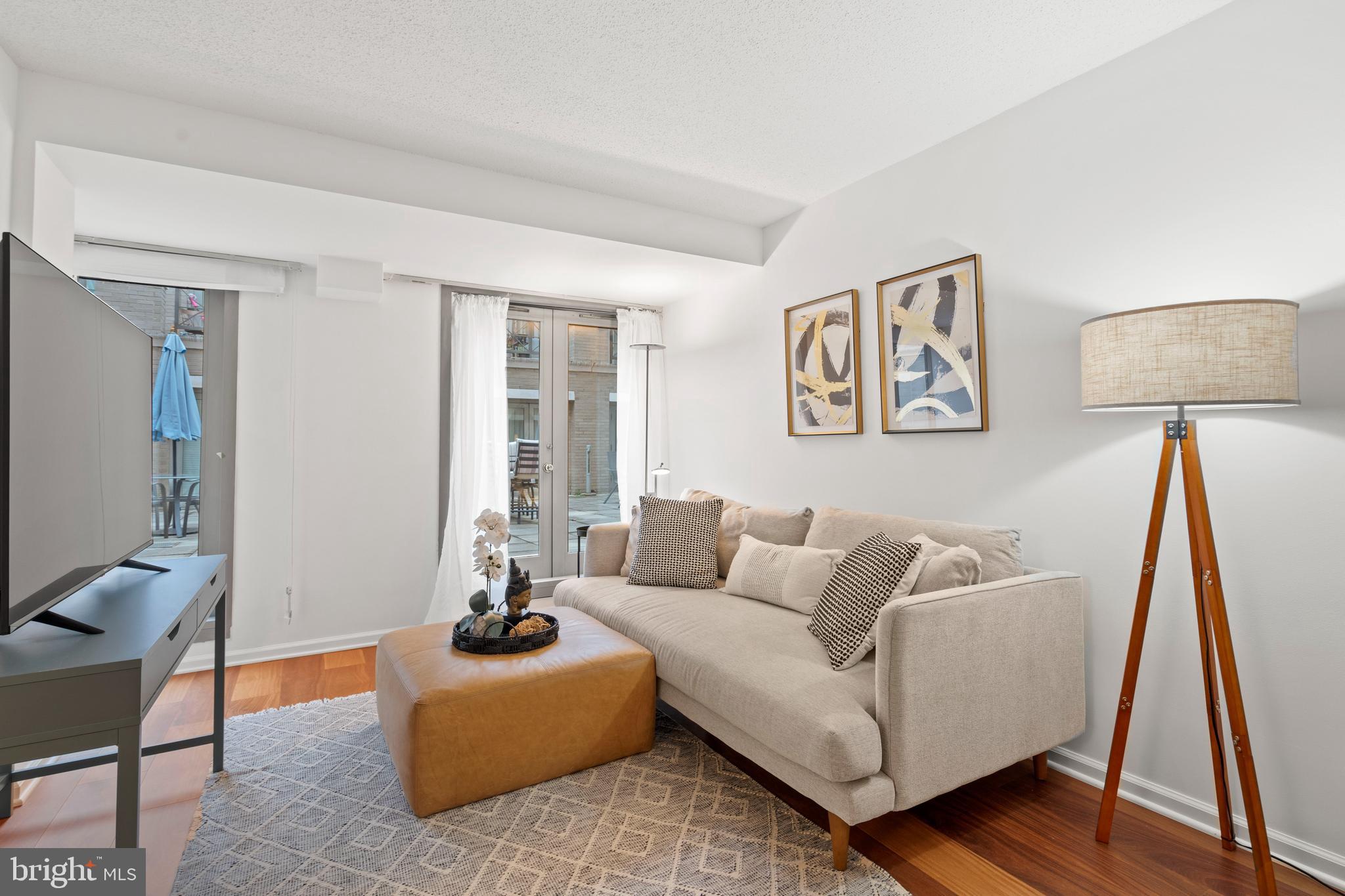 801 Pennsylvania Avenue Northwest, Unit 1125 Washington, DC 20004 - Photo 3 of 25 a living room with furniture and a wooden floor