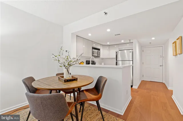 a view of a dining room with furniture and wooden floor