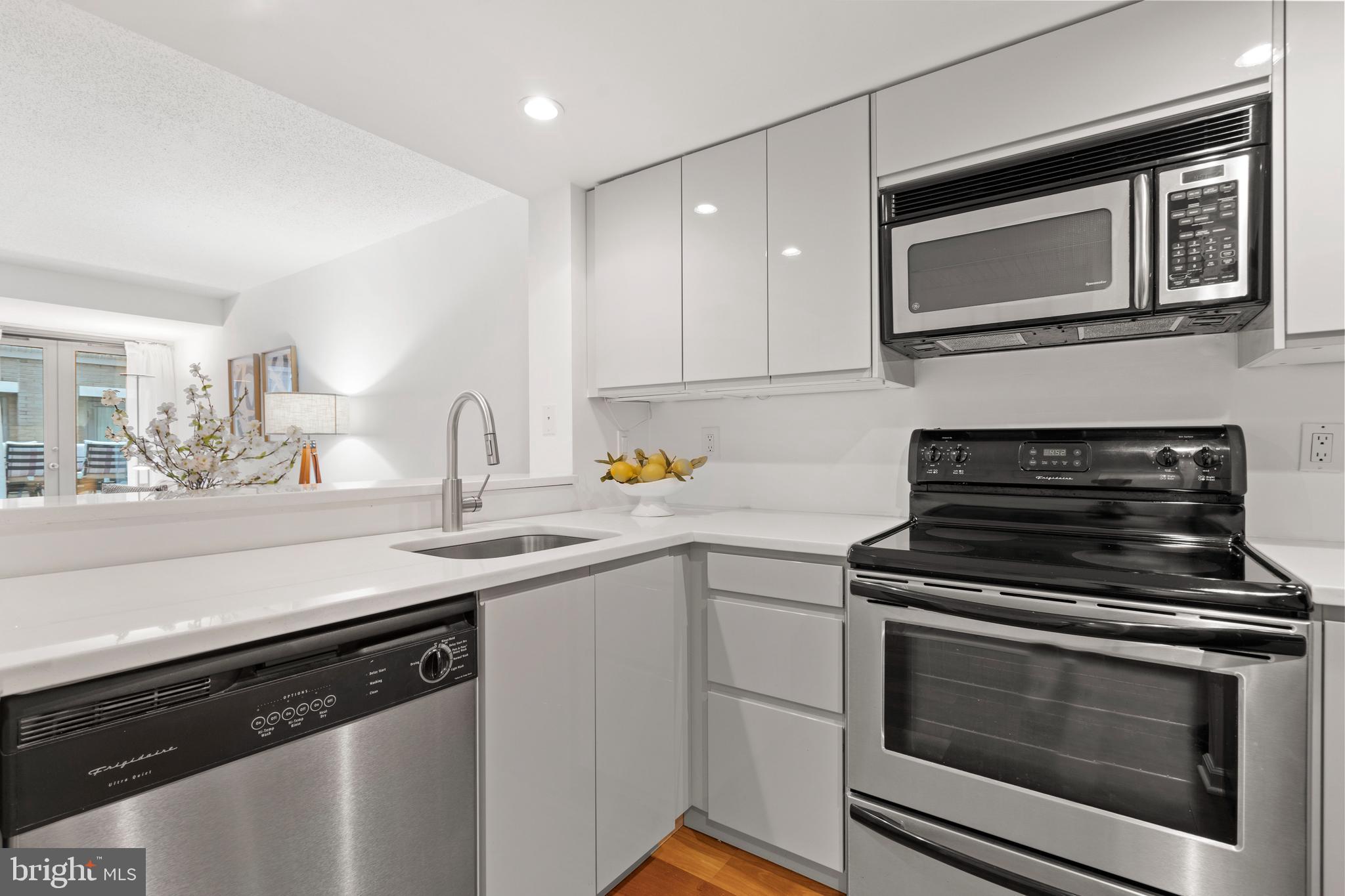 801 Pennsylvania Avenue Northwest, Unit 1125 Washington, DC 20004 - Photo 7 of 25 a kitchen with a stove and a microwave