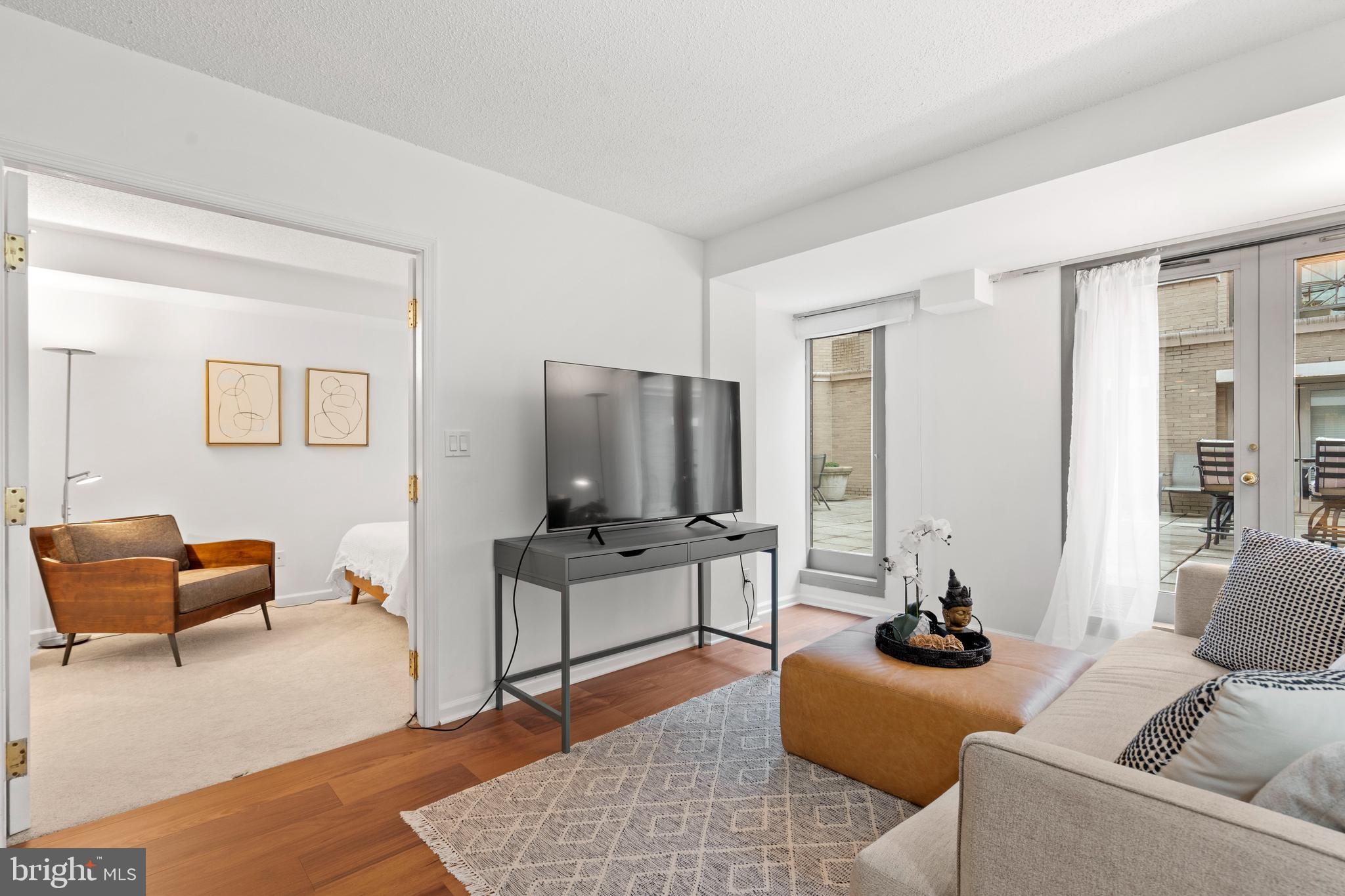 801 Pennsylvania Avenue Northwest, Unit 1125 Washington, DC 20004 - Photo 9 of 25 a living room with furniture and a flat screen tv