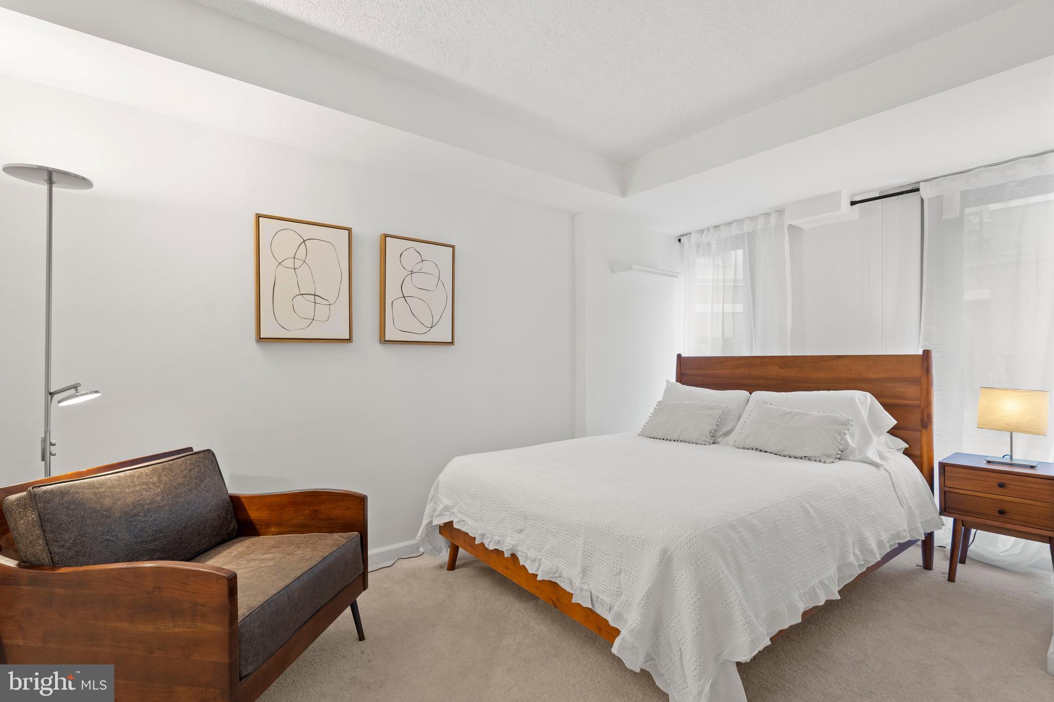 801 Pennsylvania Avenue Northwest, Unit 1125 Washington, DC 20004 - Photo 10 of 25 a bedroom with bed and couch