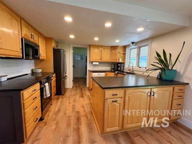 3197 Neeley Road American Falls, ID 83211 - Photo 6 of 45 Kitchen featuring wood-finish flooring, recessed lighting, wood cabinetry, dark countertops, and a white subway tile backsplash
