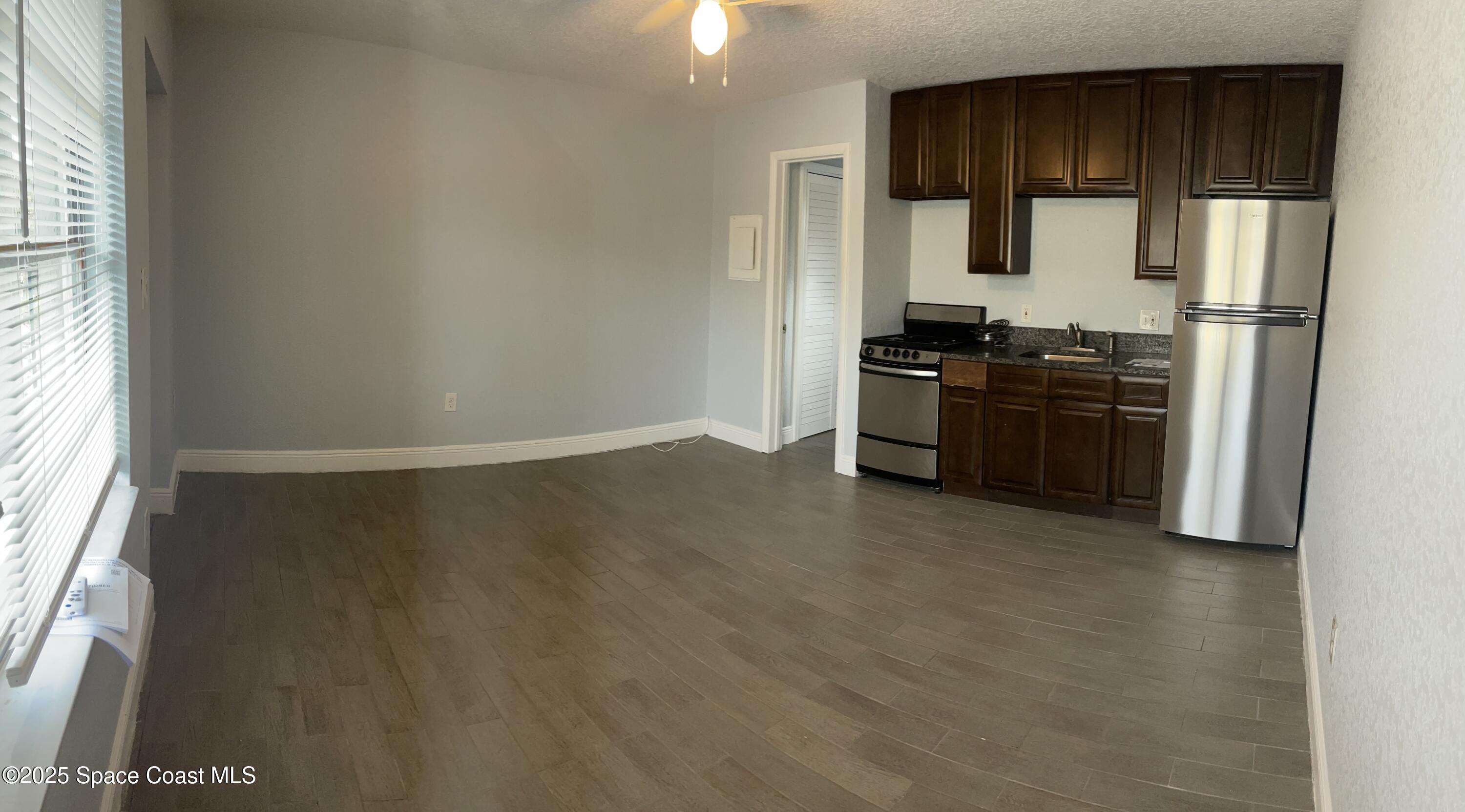 6100 Ridgewood Avenue, Unit 1 Cocoa Beach, FL 32931 - Photo 3 of 16 a kitchen with a refrigerator and a stove