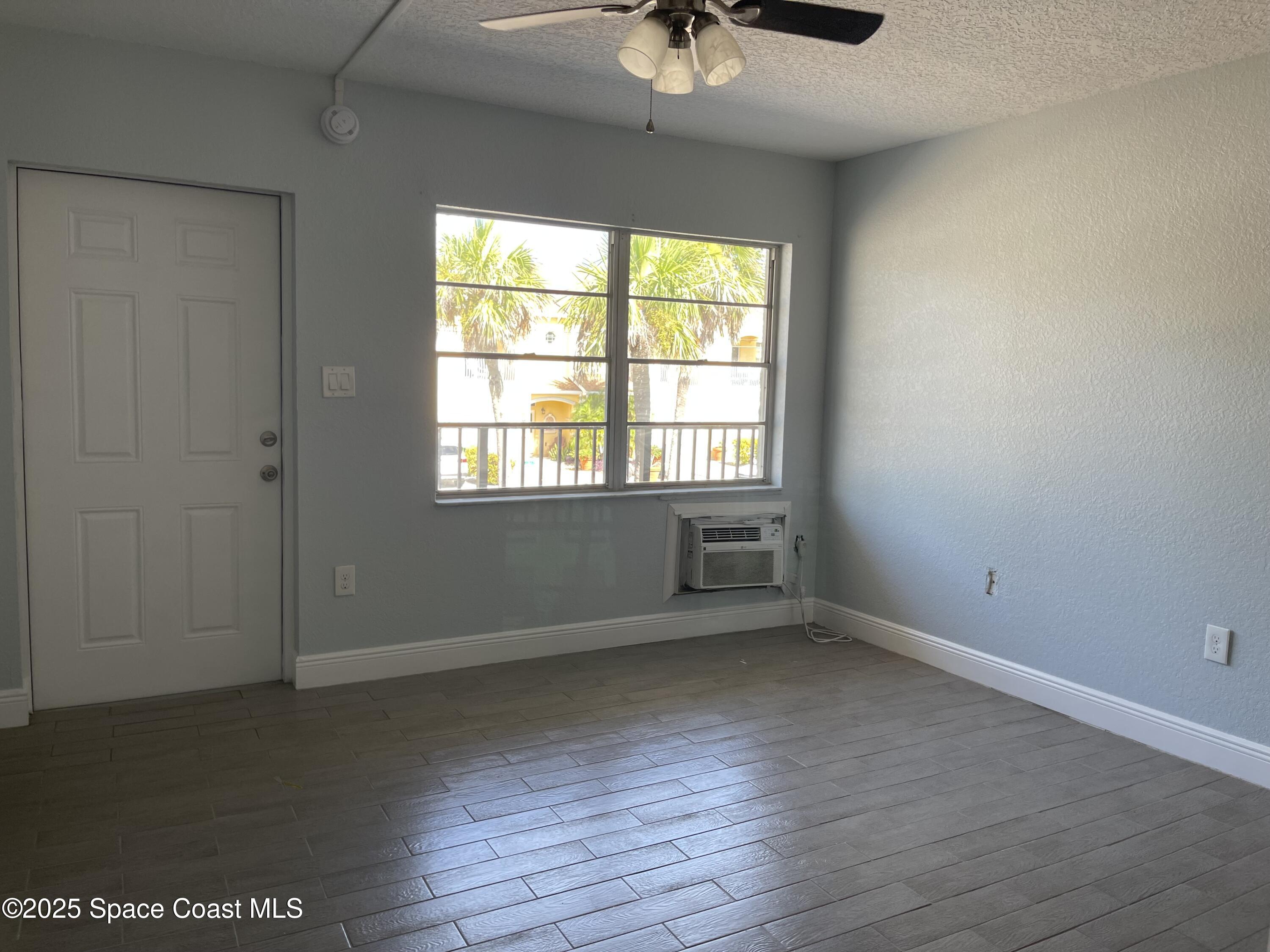 6100 Ridgewood Avenue, Unit 1 Cocoa Beach, FL 32931 - Photo 8 of 16 an empty room with a window