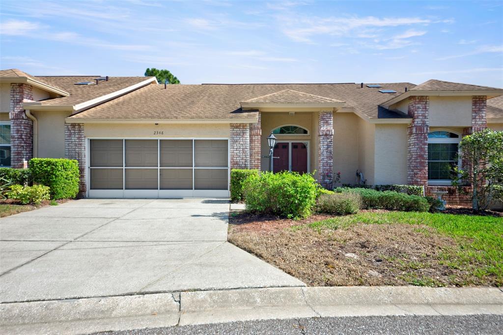 front view of a house with a yard and potted plants