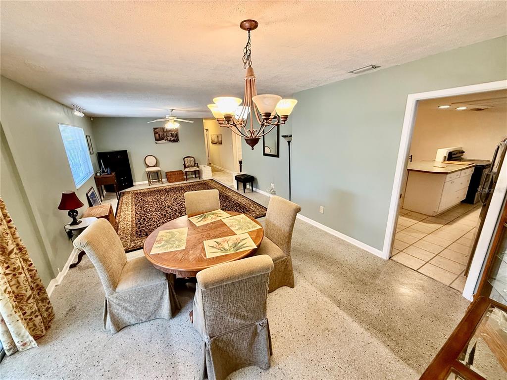 1004 Connecticut Road Tarpon Springs, FL 34689 - Photo 13 of 57 a view of a dining room with furniture and a chandelier
