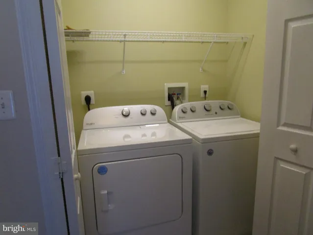 a living room with a fireplace and a ceiling fan