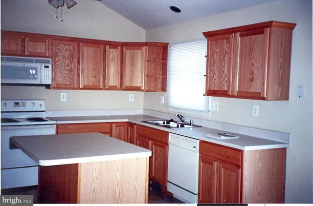 a kitchen with stainless steel appliances a stove a refrigerator a sink and cabinets