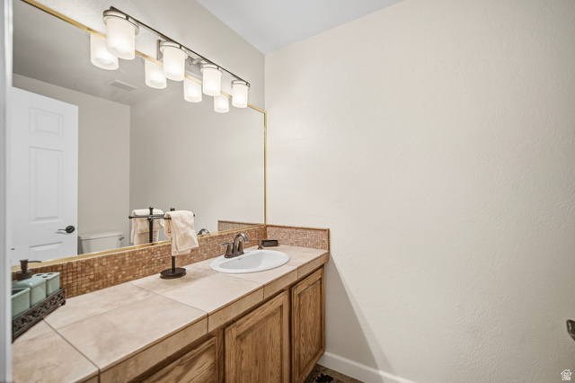 1985 West Rivers Edge Lane St. George, UT 84770 - Photo 32 of 42 Half bath with vanity and toilet