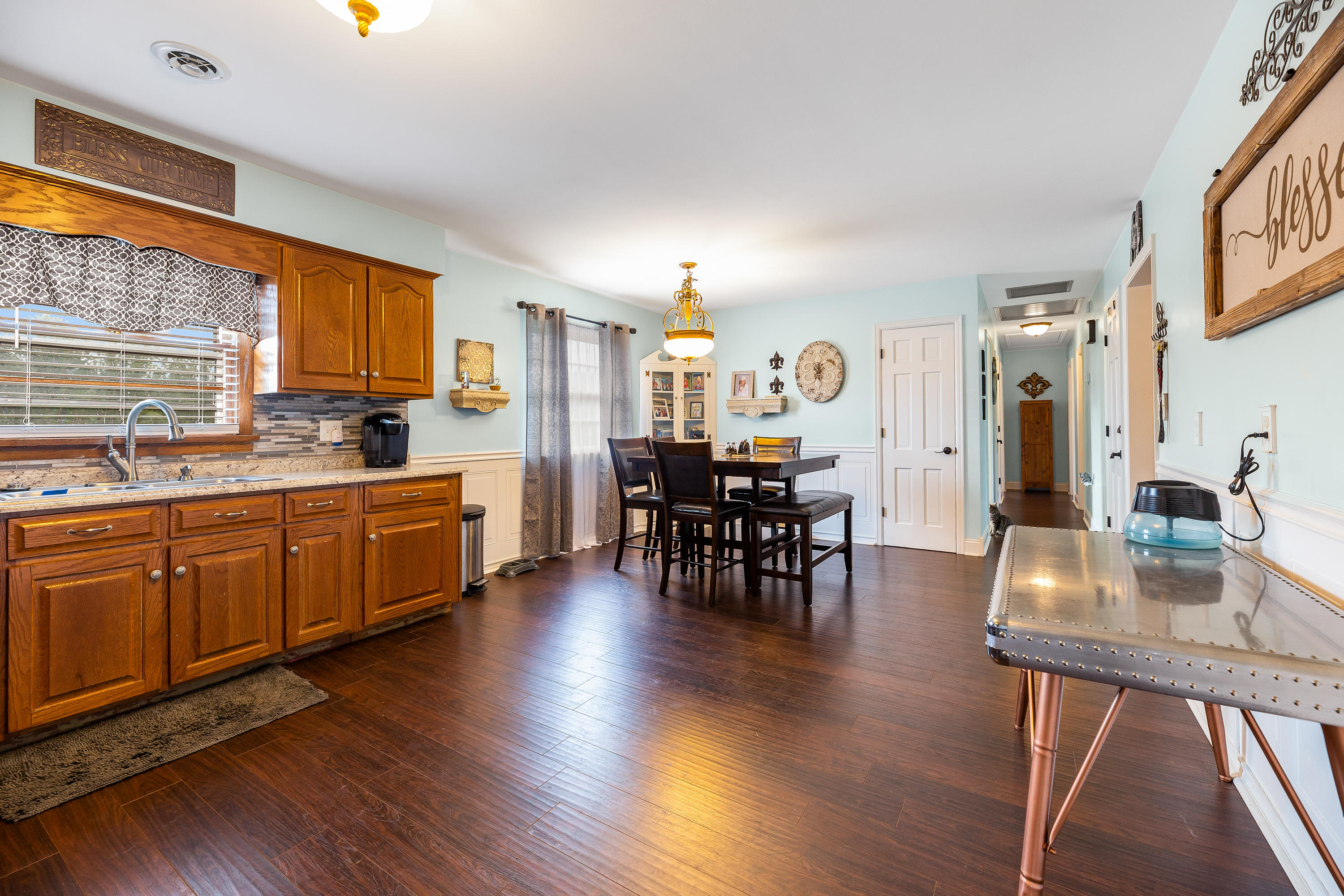 6543 Goodview Road Goodview, VA 24095 - Photo 10 of 21 a kitchen with stainless steel appliances granite countertop wooden floors and white cabinets