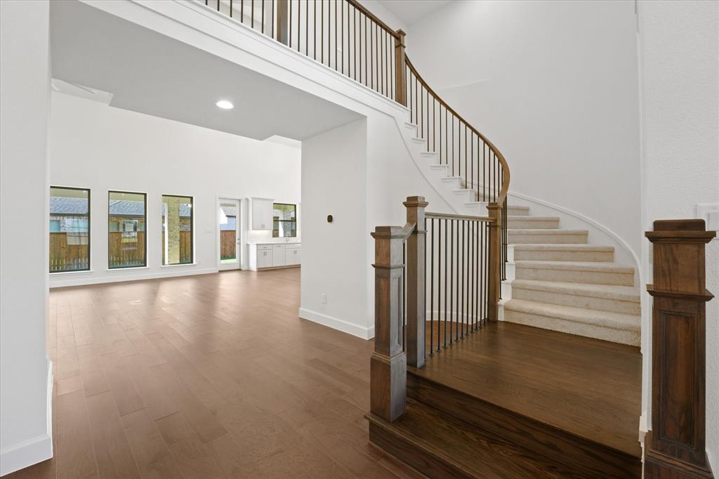 4626 Rillstone Road Midlothian, TX 76065 - Photo 3 of 40 Stairway featuring a towering ceiling, wood finished floors, and recessed lighting