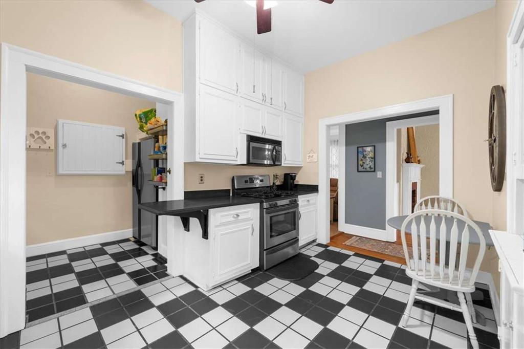106 Westmore Road Southwest Rome, GA 30165 - Photo 12 of 56 a kitchen with a checkered floor and white cabinets