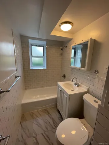 a bathroom with a sink a toilet and bathtub