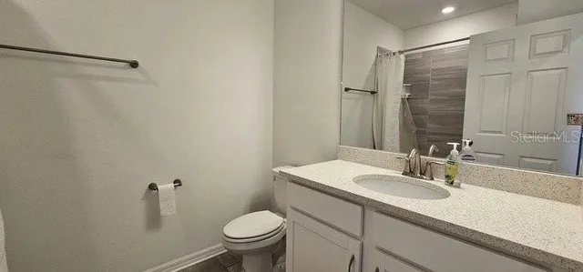 a bathroom with a sink toilet and vanity