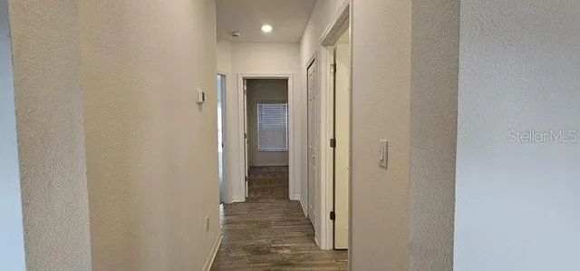 a view of a hallway with a dining area