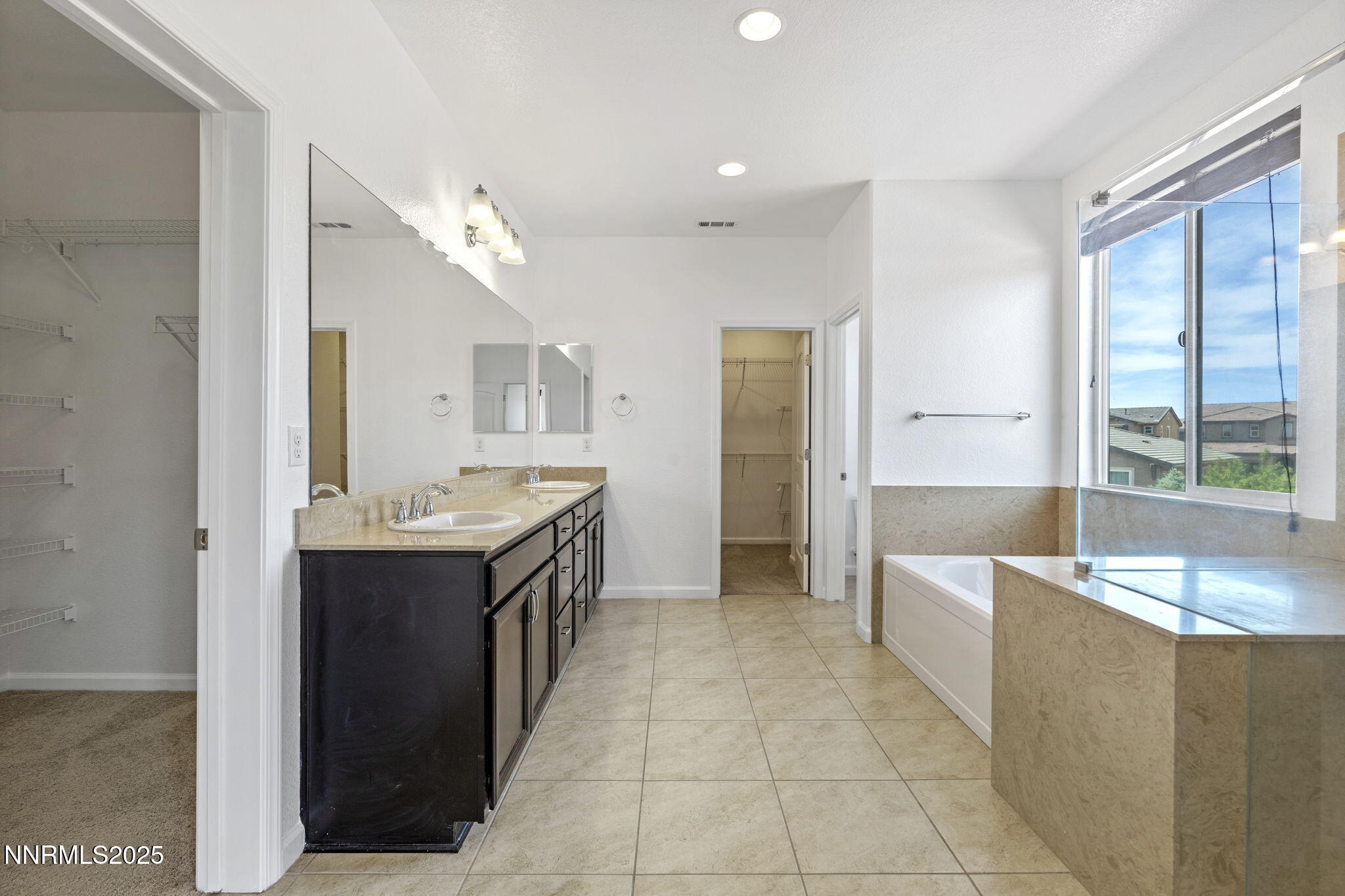 2028 Bayview Drive Reno, NV 89521 - Photo 19 of 33 a large bathroom with a granite countertop tub a double vanity sink a mirror and a shower