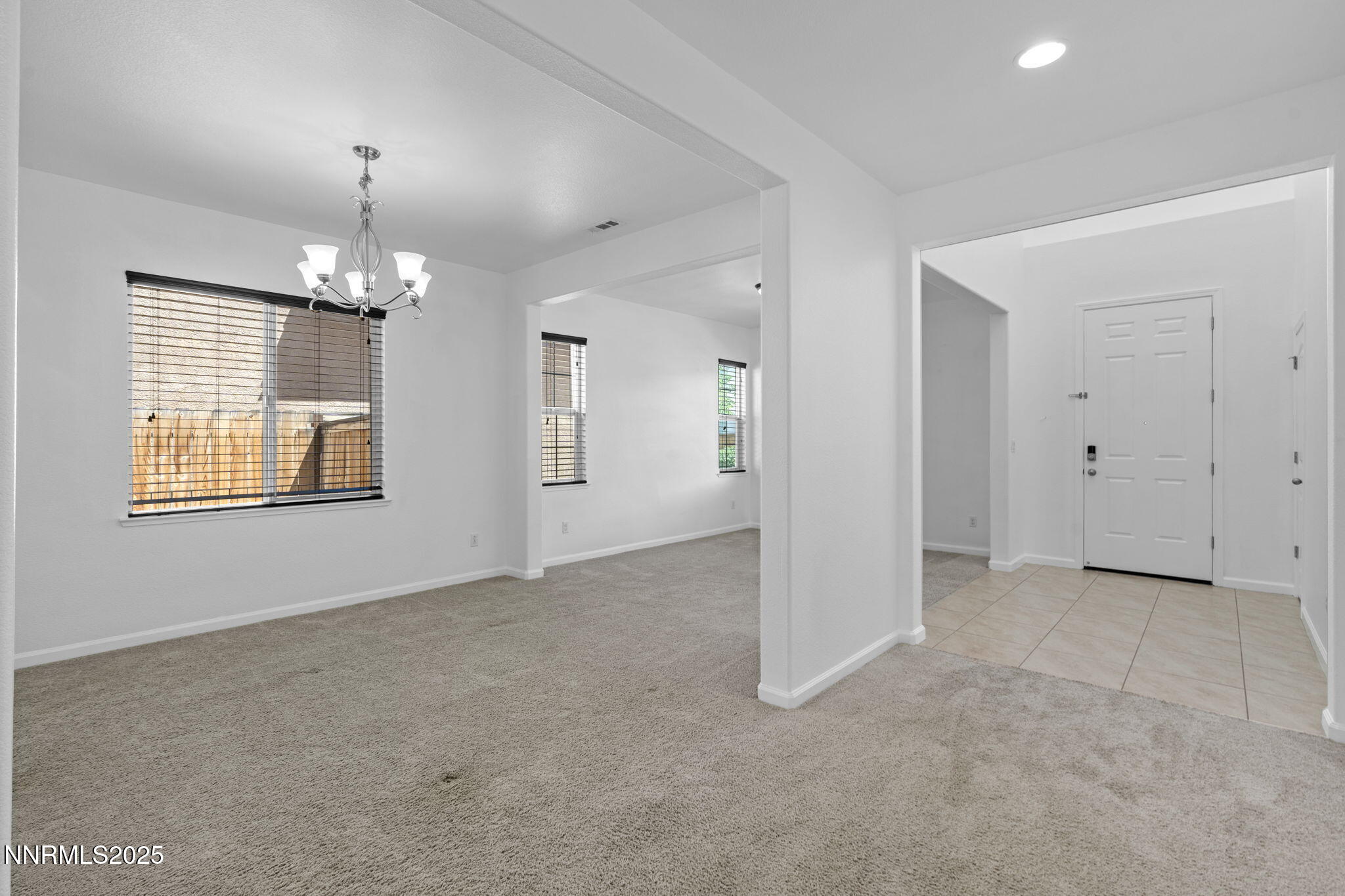 2028 Bayview Drive Reno, NV 89521 - Photo 2 of 33 an empty room with chandelier and windows