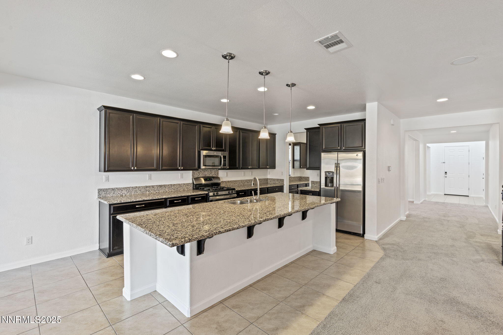 2028 Bayview Drive Reno, NV 89521 - Photo 6 of 33 a large kitchen with a large counter top stainless steel appliances and cabinets