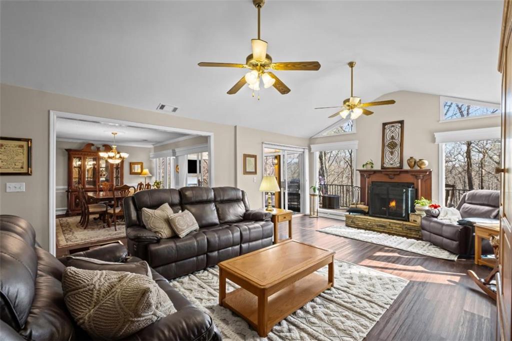 119 Soaring Hawk Circle Big Canoe, GA 30143 - Photo 11 of 50 a living room with furniture a fireplace and a chandelier