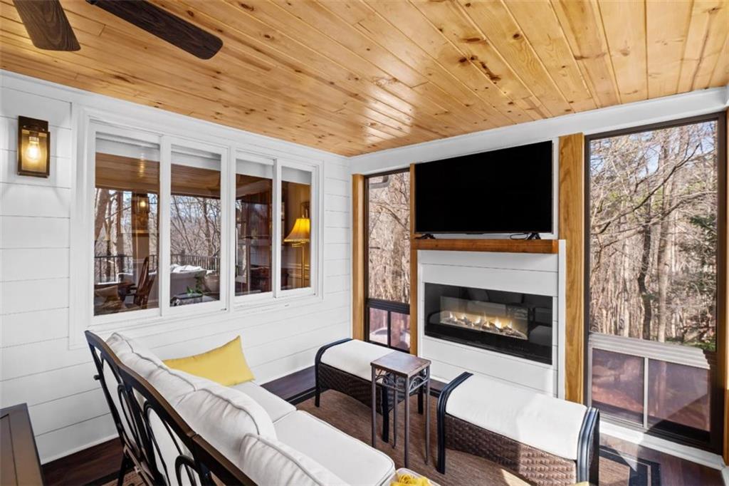 119 Soaring Hawk Circle Big Canoe, GA 30143 - Photo 16 of 50 a living room with furniture a flat screen tv and a fireplace