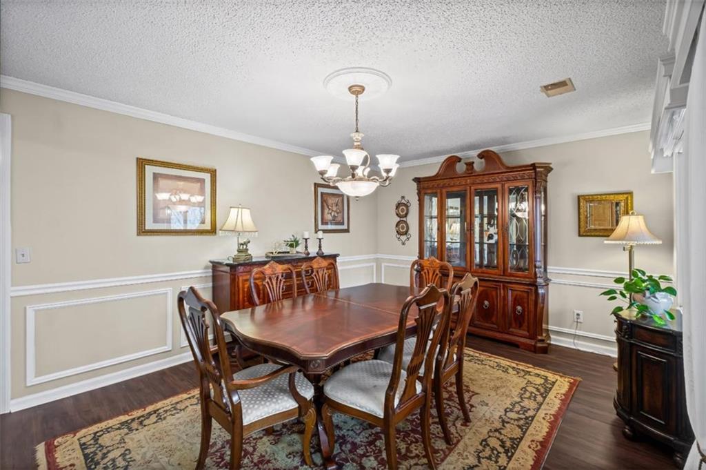 119 Soaring Hawk Circle Big Canoe, GA 30143 - Photo 23 of 50 a view of a dining room with furniture and wooden floor