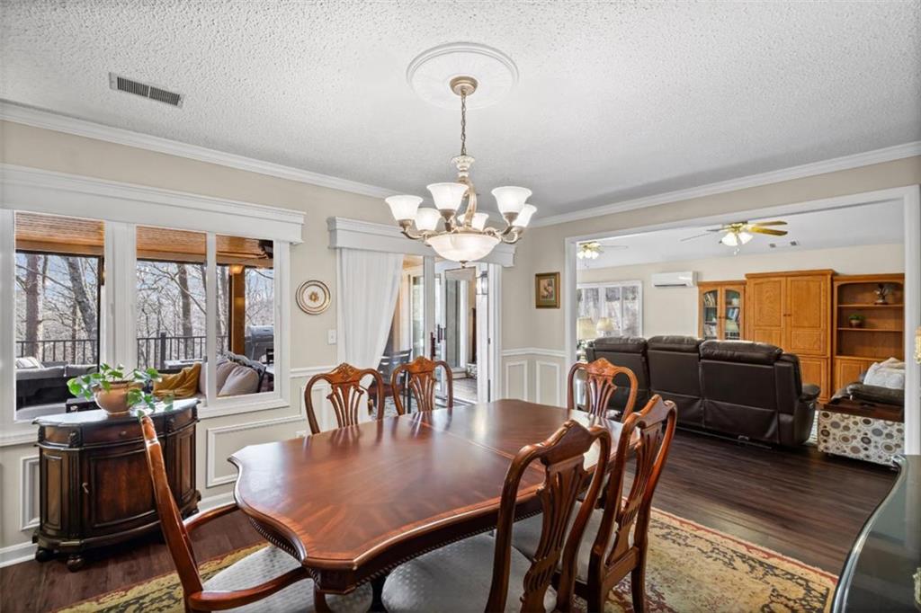 119 Soaring Hawk Circle Big Canoe, GA 30143 - Photo 24 of 50 a view of a dining room with furniture a chandelier and wooden floor