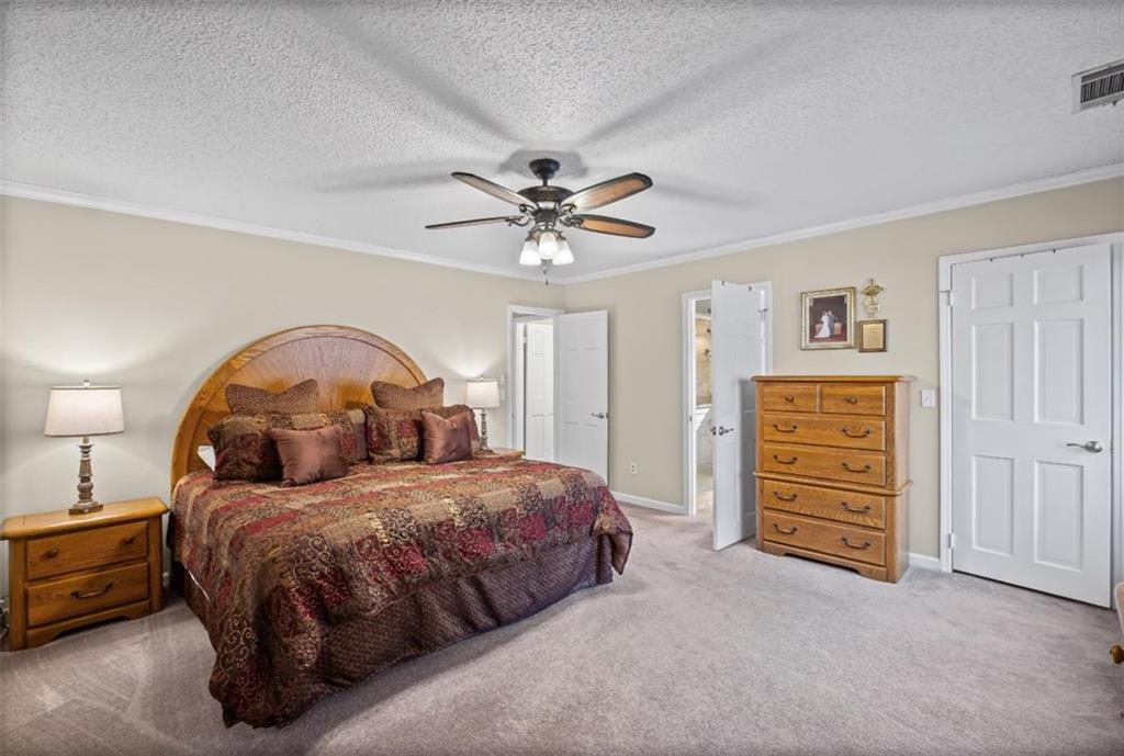 119 Soaring Hawk Circle Big Canoe, GA 30143 - Photo 25 of 50 a bedroom with bed and a chandelier