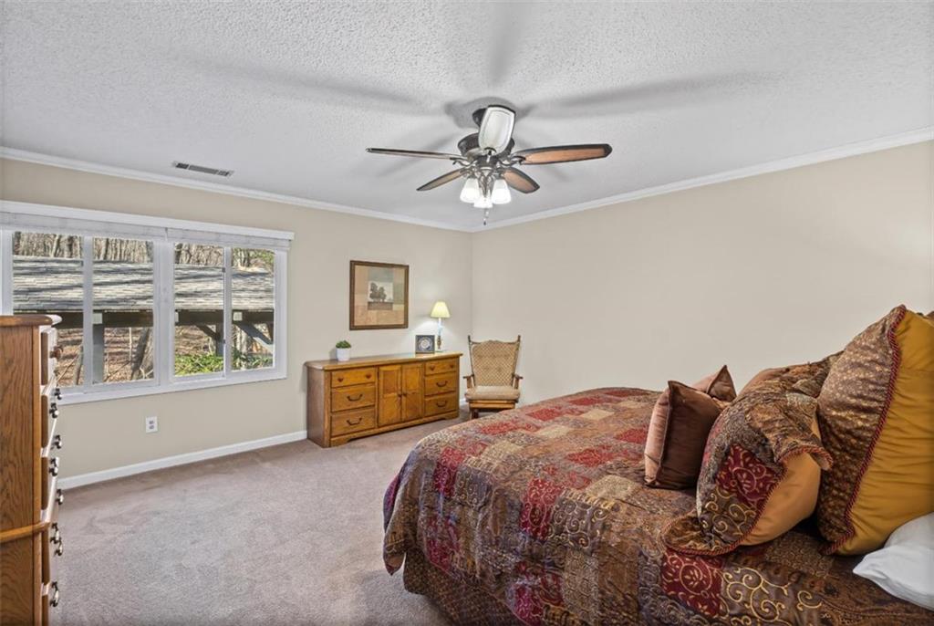 119 Soaring Hawk Circle Big Canoe, GA 30143 - Photo 26 of 50 a spacious bedroom with a bed and dresser