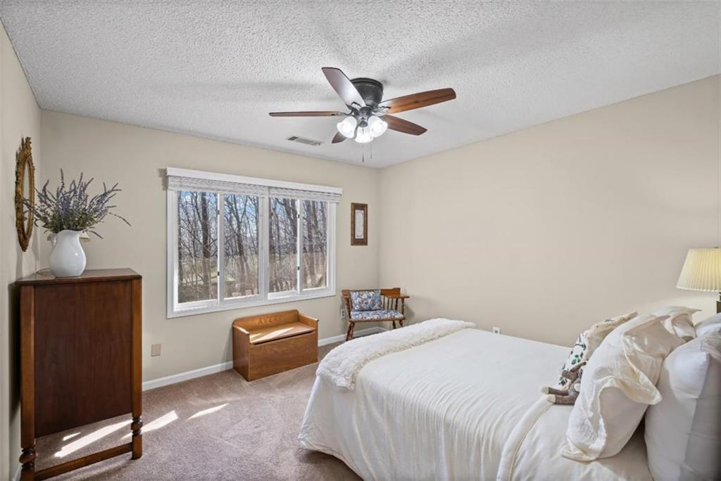 119 Soaring Hawk Circle Big Canoe, GA 30143 - Photo 29 of 50 a bedroom with a bed and a couch