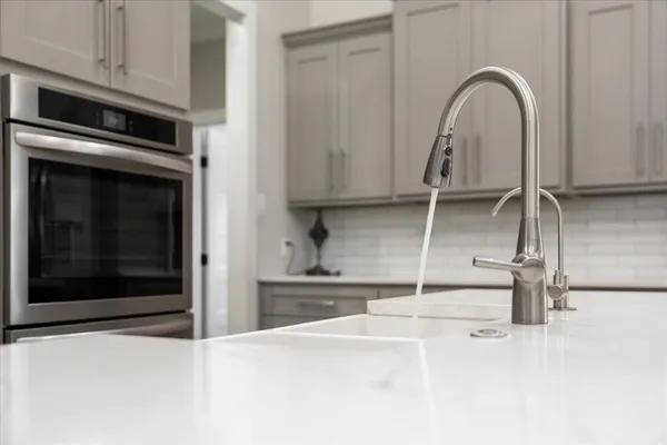 a kitchen with a sink and a stove top oven