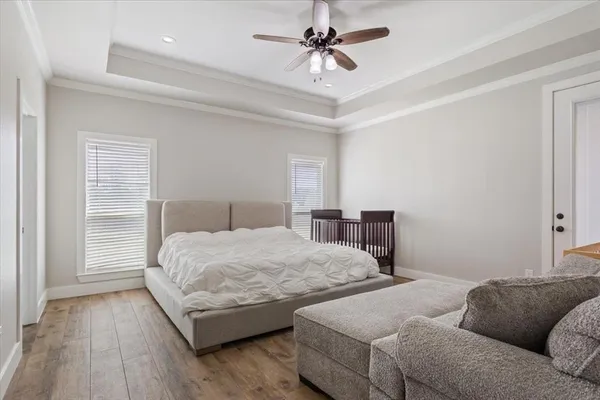 a bedroom with a bed couch and a window