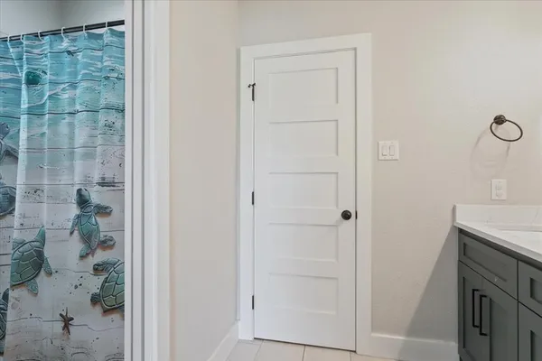 a bathroom with a shower and a sink