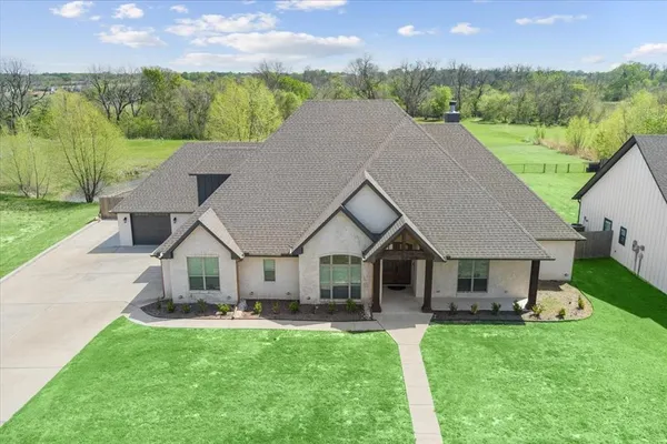 a aerial view of a house with swimming pool and a yard