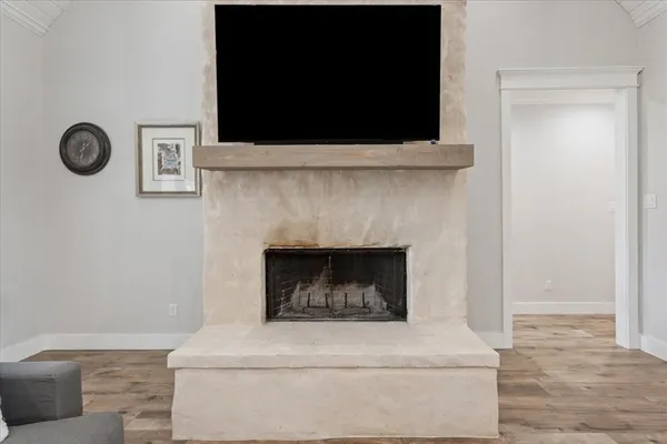 a living room with a fireplace and a flat screen tv