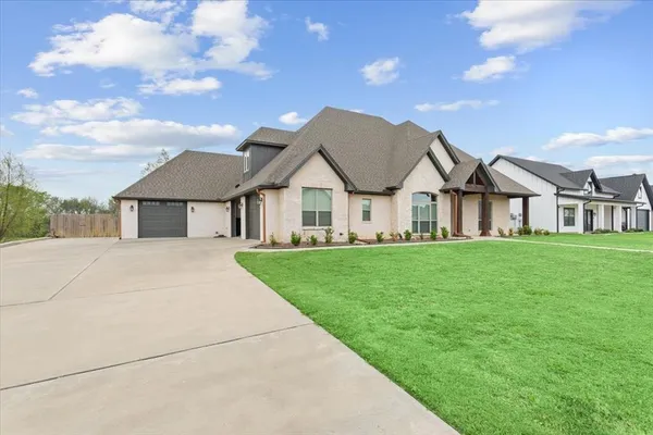 a view of house that has a yard