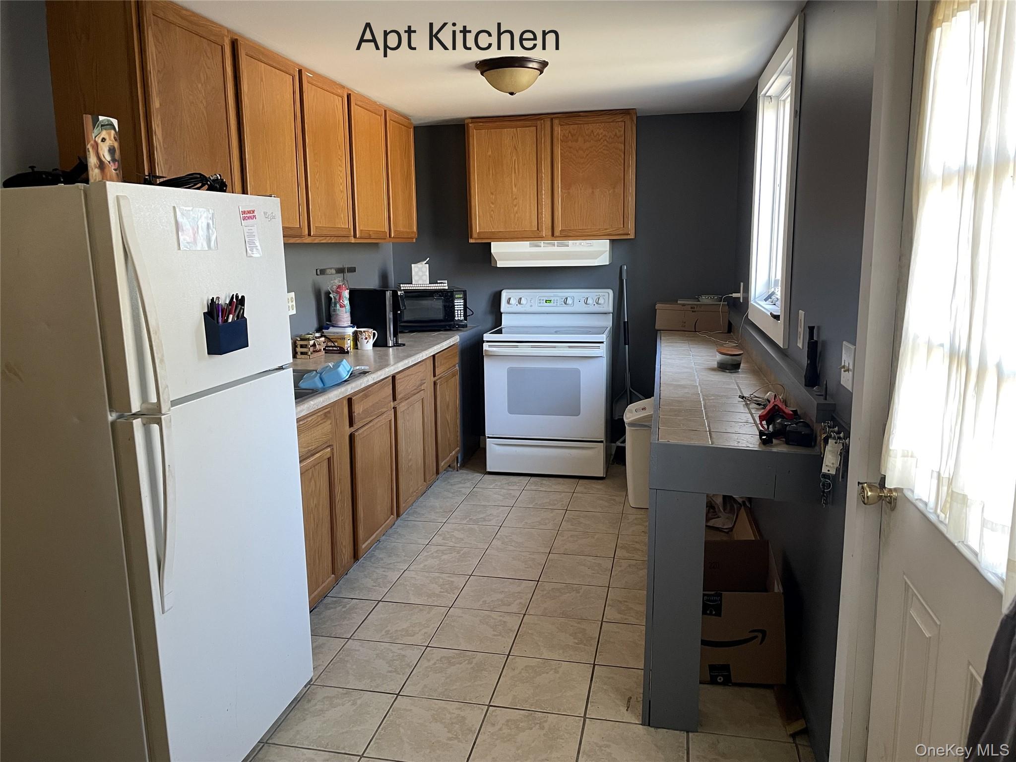239 Rokeby Road Red Hook, NY 12572 - Photo 20 of 25 a kitchen with a refrigerator a stove top oven and cabinets