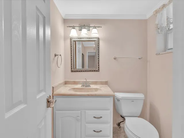 a kitchen with stainless steel appliances granite countertop a refrigerator a stove a sink and white cabinets