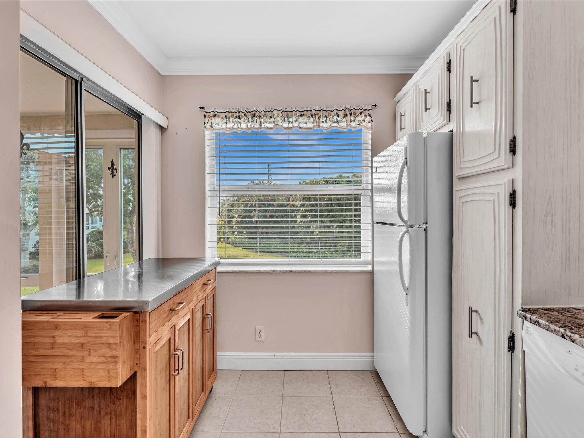 33 Colonial Club Drive, Unit 203 Boynton Beach, FL 33435 - Photo 15 of 61 a view of kitchen with granite countertop cabinets and a large window